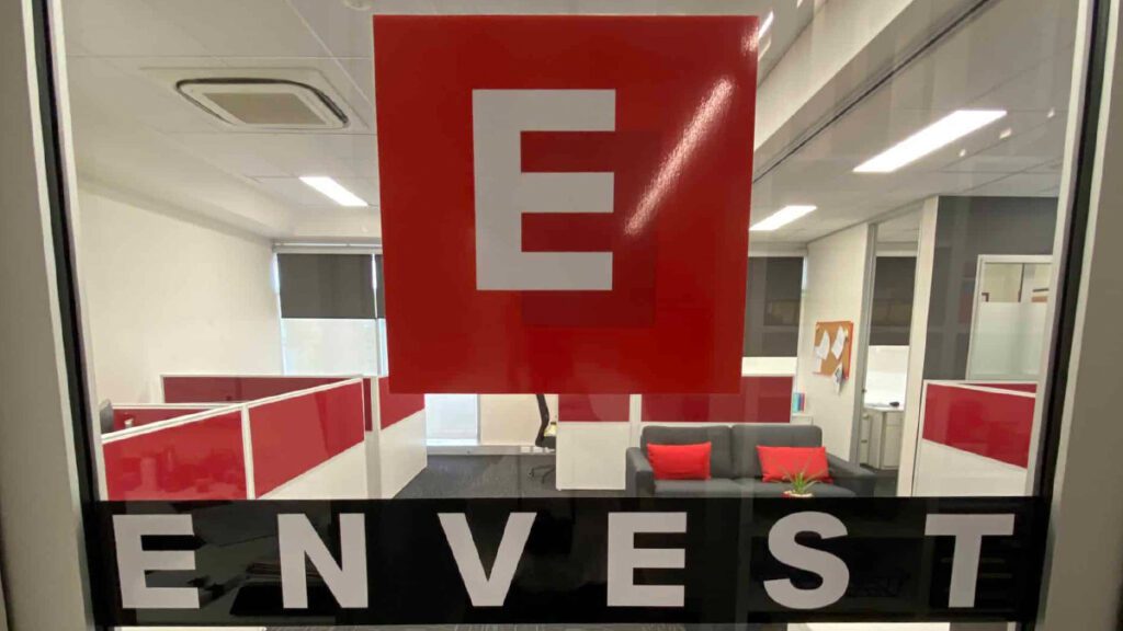 Envest logo stuck on an office window | Featured Image for Tribella Group