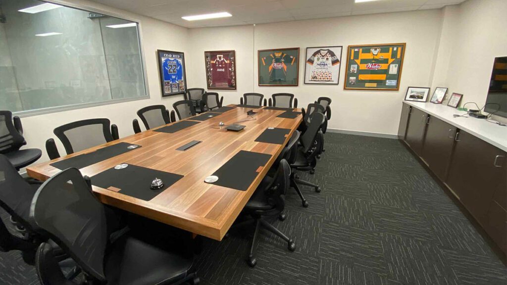 Boardroom with large table and chairs on the outside | Featured Image for Tribella Group