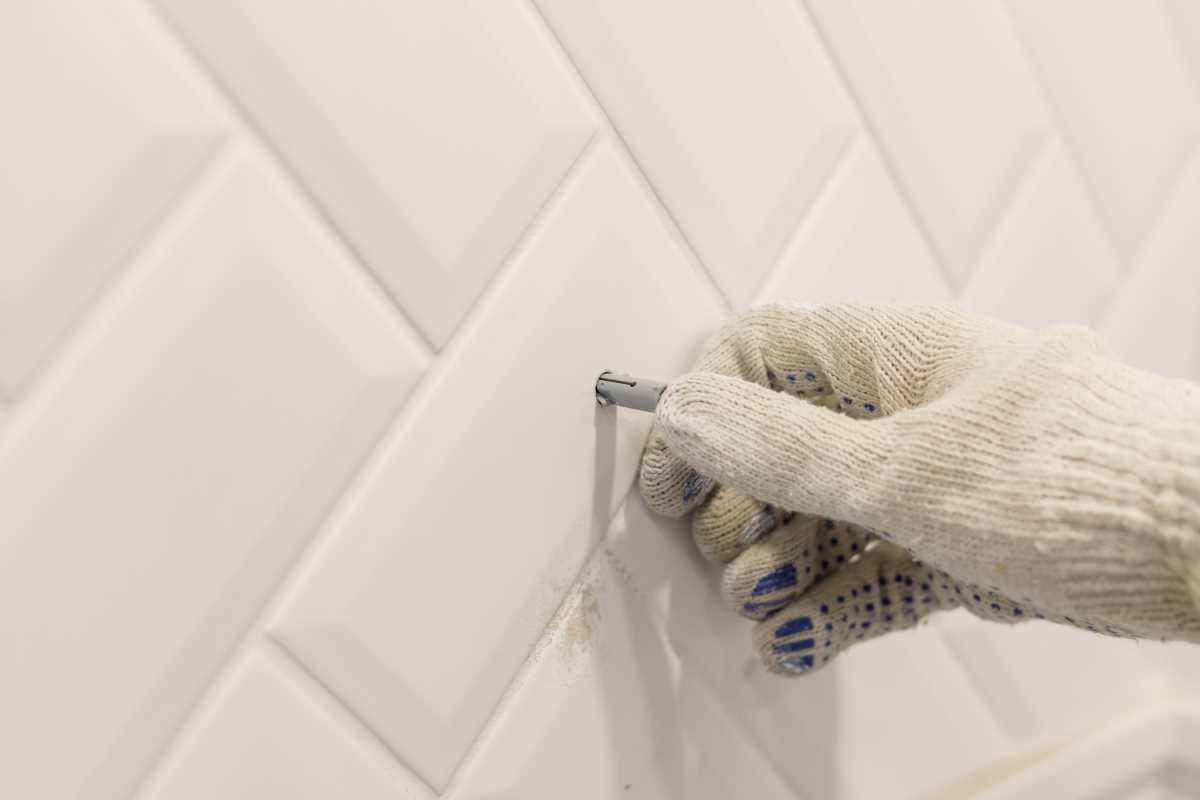Contractor completing tiling work | Featured image for the Home Repair Services Page for Tribella Group.