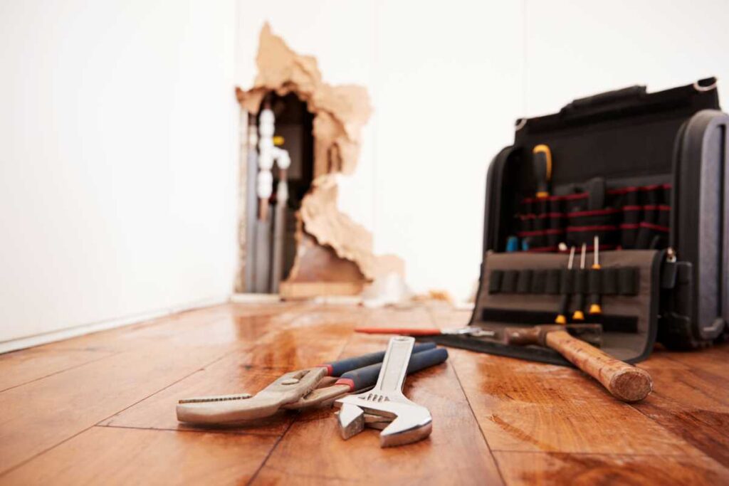 Toolbox laying on the floor | Featured image for the Home Repair Services Page for Tribella Group.